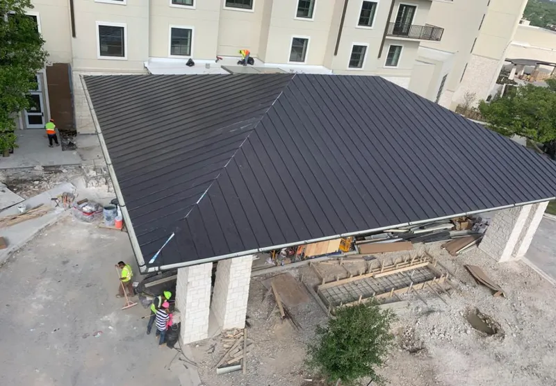 Metal roofing installation team working on a commercial building in Yarmouth